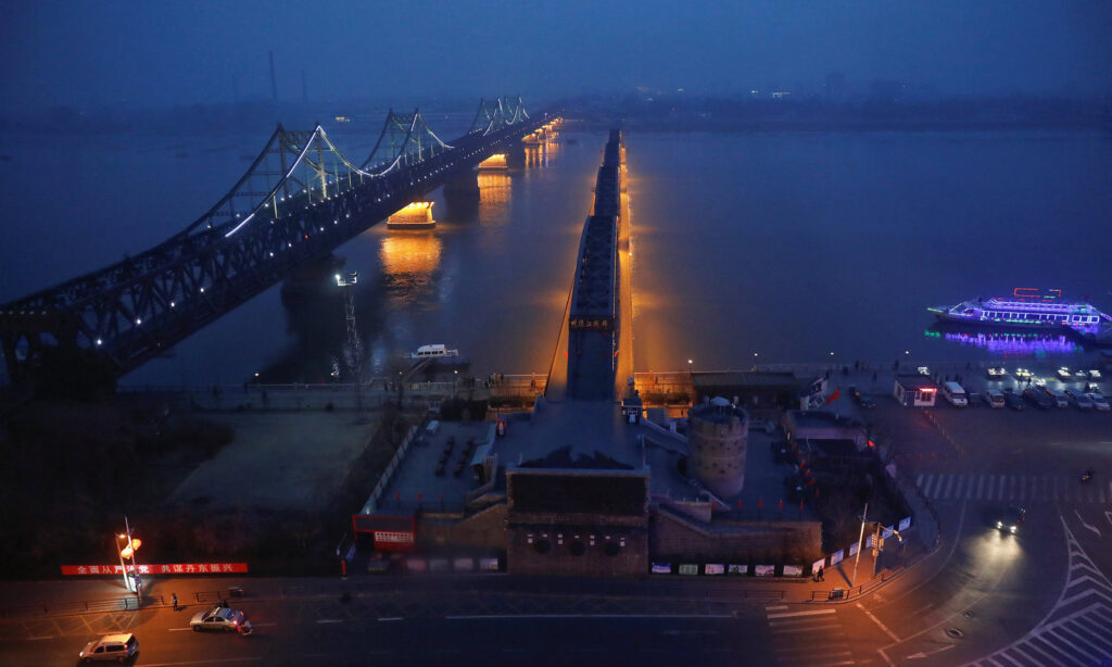 Night View of a Historic Bridge Illuminated Over River